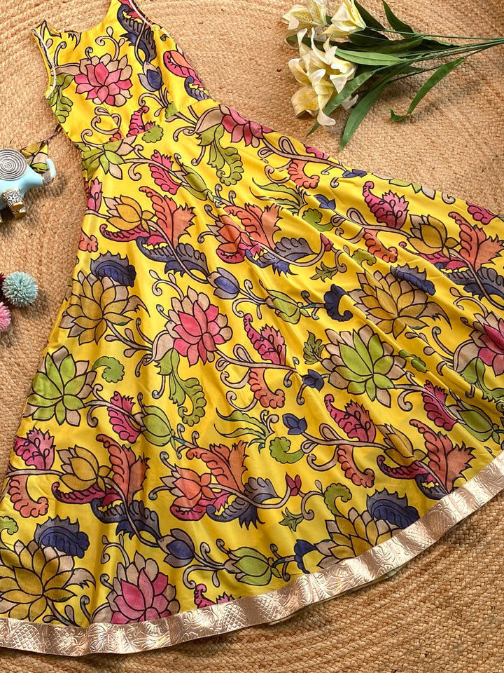 Girls Yellow Tussar Silk Gown with Pen Kalamkari Floral Print & Gota Detailing