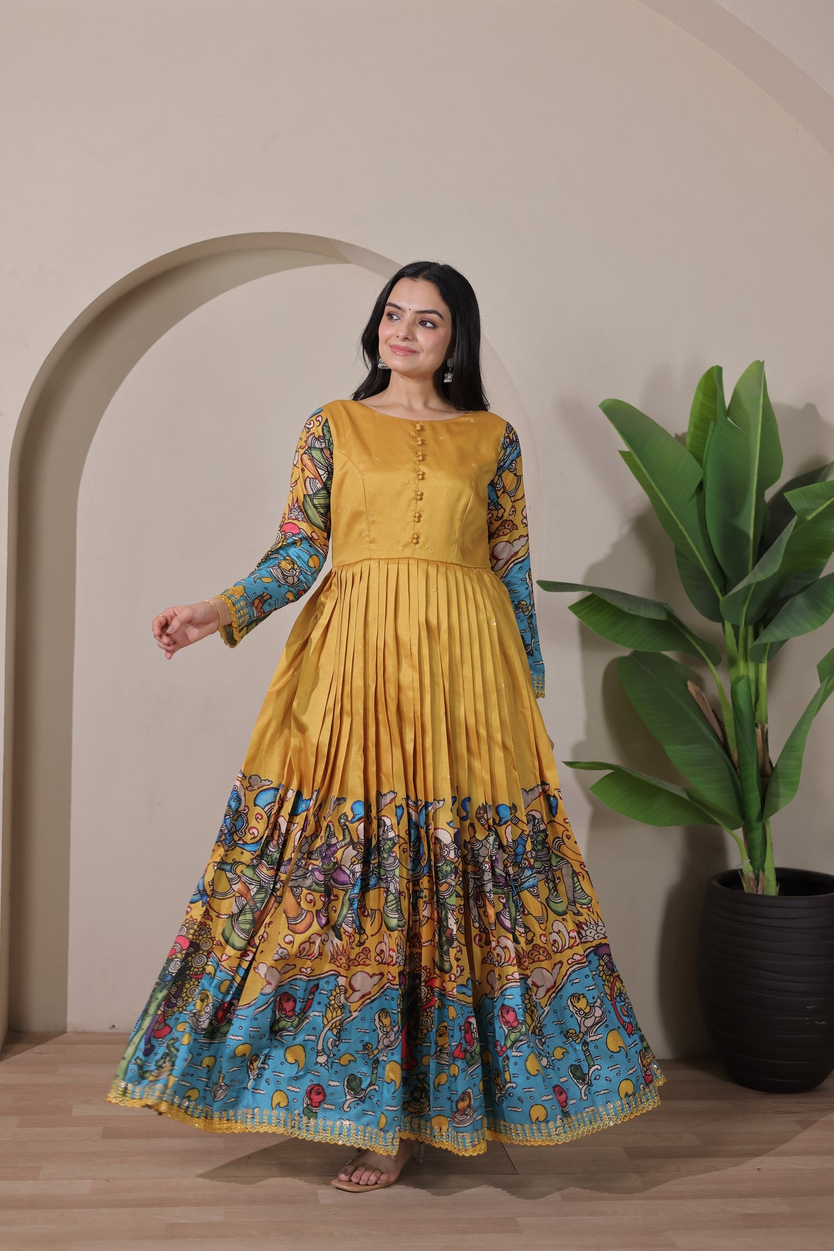 stunning flared yellow gown with pen kalamkari design